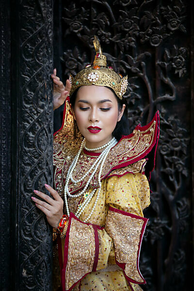 Bildagentur | mauritius images | Woman In Traditional Dress Standing At  Buddhist Temple